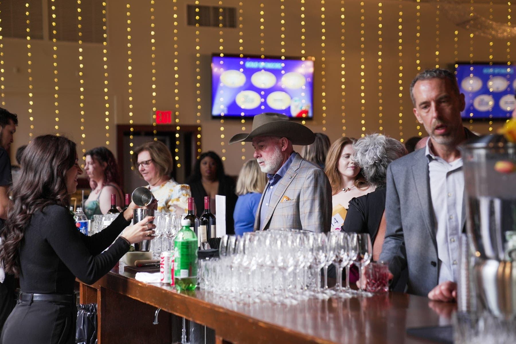 Guests at the bar during a fundraising gala reception, event photography by Lenny J Media