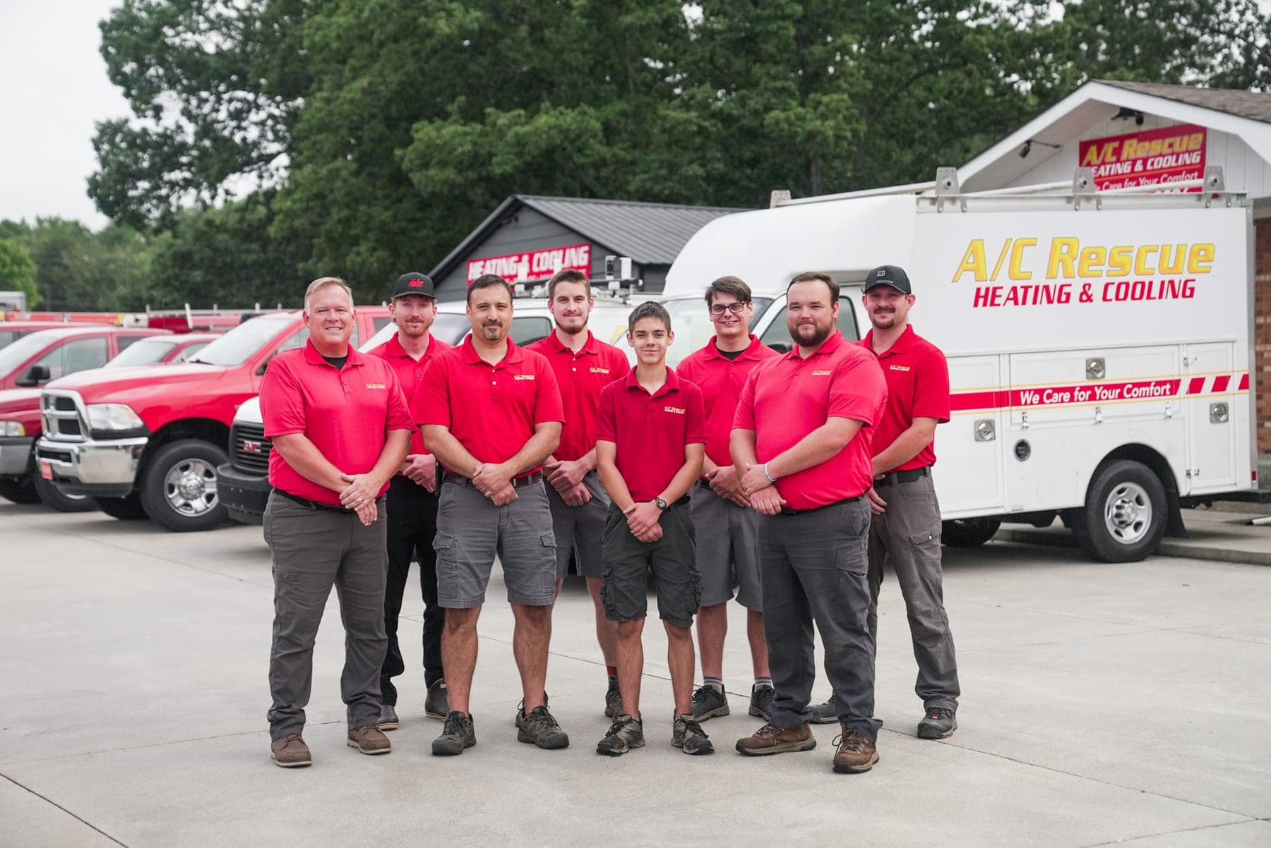 The A/C Rescue Heating & Cooling team in front of their service trucks, team photography by Lenny J Media