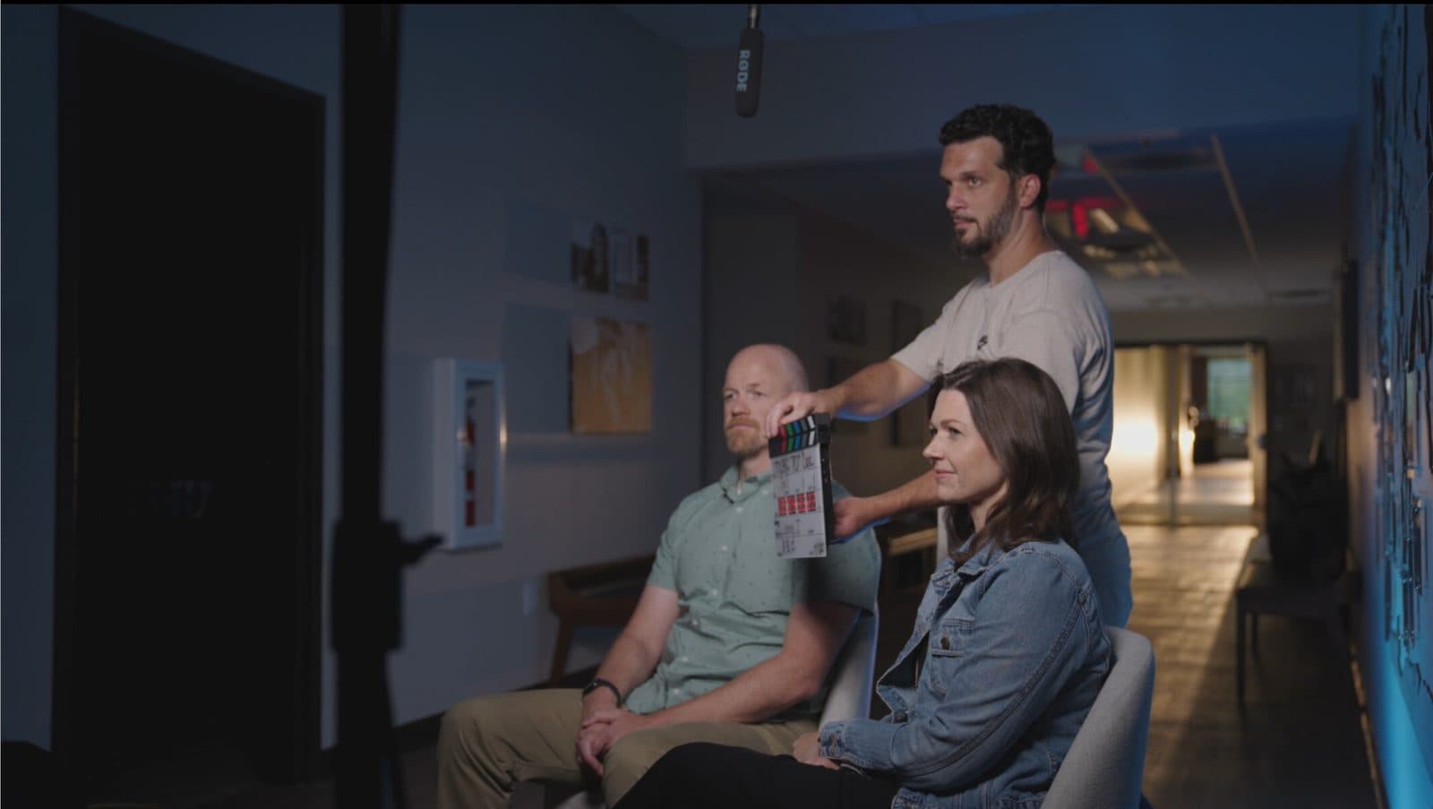 Lenny J Media on set — marking a shot with a clapperboard during an interview production