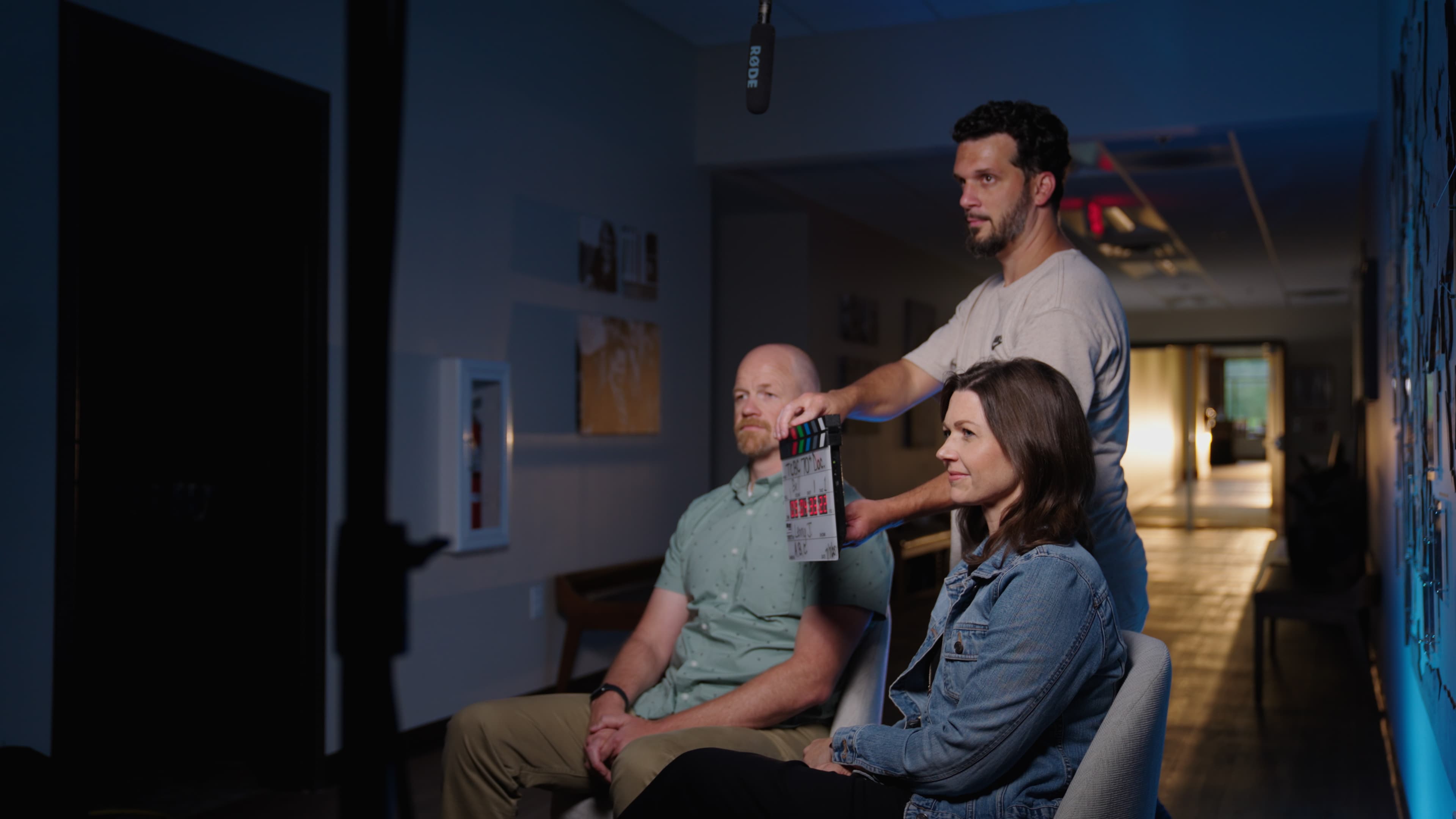 Lenny J Media on set — marking a shot with a clapperboard during an interview production
